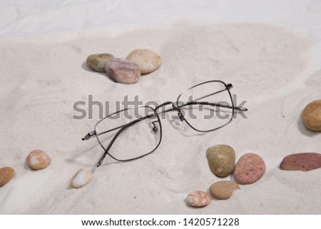 Image of glass products taken in studio with sand background , stone 