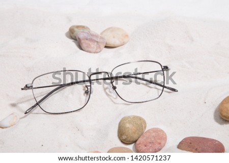 Image of glass products taken in studio with sand background , stone 