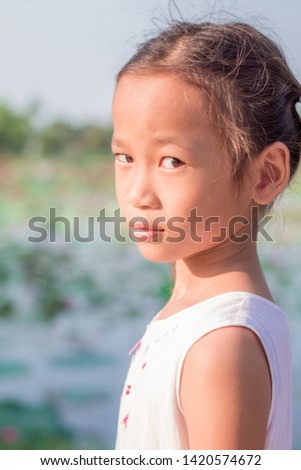 close up portrait children. asian cut little gril in park at thailand