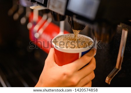 man pours a fizzy drink.sparkling water.cool ice soft drink cola Royalty-Free Stock Photo #1420574858