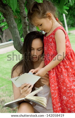 Mother and daughter looking at photos of the park