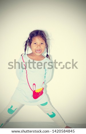 Beautiful asian kid smile hair bundle happy on her bed. Vintage tone.