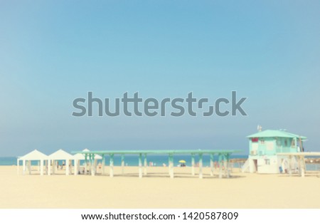 Summer vacation and travel holiday concept. Bokeh tropical beach with saver cabin. abstract background. Vintage tone filter