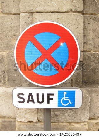 Sign in French denoting Handicap Only parking.  Circle with blue background and Red X in a circle.  The word safe and a wheelchair icon are below the circle.
