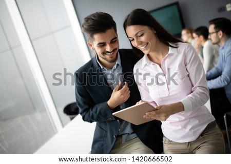 Happy young business colleagues in modern office Royalty-Free Stock Photo #1420666502
