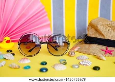 Sunglasses and hat with colorful background. Bright summer background. Summer stuff flat lay. Summer concept.
