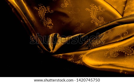 Texture background pattern Yellow mustard brown chiffon fabric with paisley print High quality pure silk chiffon fabric bright beautiful color combinations This fabric is suitable for design wallpaper