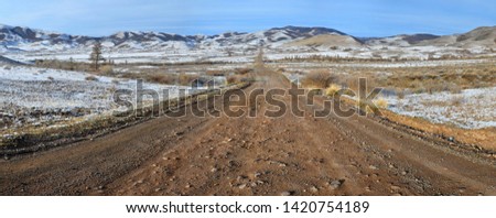 Mountainous spring landscape. Dirt, unpaved road to Mongun-Taiga district. Tuva (Tyva, Tyva Republic), Siberia, Russia, Asia.