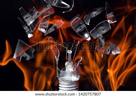 The explosion of a glass lamp. Fire and shattered glass. The dynamic picture of the explosion. High energy.