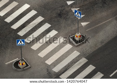Top view of empty pedestrian crossing with street signs, zebra traffic walk in the city
