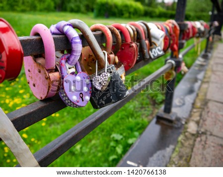 Bridge of eternal love with padlocks with the names of the newlyweds. The names of the newlyweds are written on the padlocks and wishes of love and happiness are stamped in metal or paint.