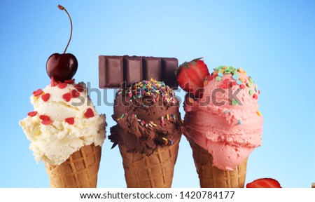 Set of ice cream scoops of different colors and flavours with berries, sprinkles decoration on white background