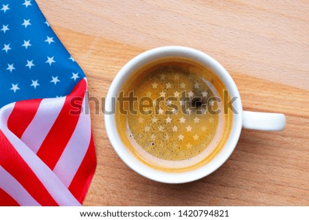 Independence Day USA concept. Memorial Day. Cup of coffee with American flag on white background top view