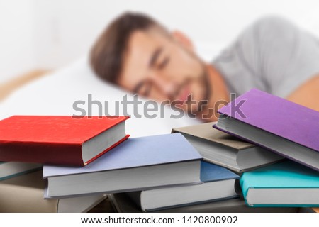 Tired teen girl falling asleep exhausted after long hours of learning exam test preparations, deprived college student sleeping sitting on couch having nap dozing on sofa holding book bored of study