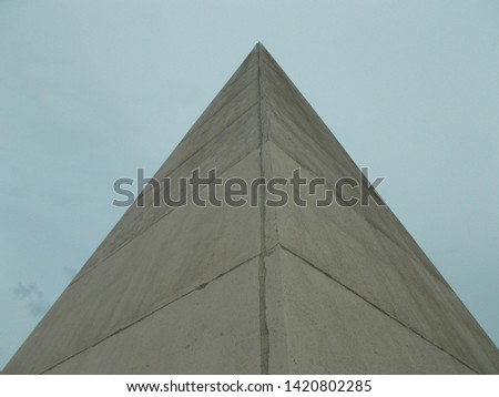 
Background image of a pyramid of concrete slabs