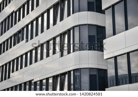 Abstract fragment of modern architecture, walls of glass and concrete .