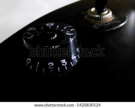 Close-up photo of black matte electric guitar. 