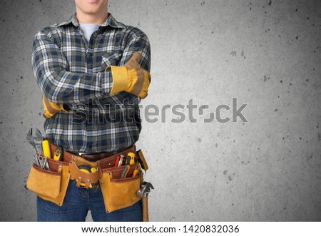 Worker with a tool belt. Isolated over white background. Royalty-Free Stock Photo #1420832036