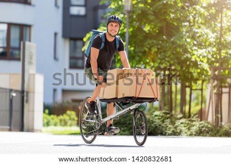 Bicycle messenger making a delivery on a cargo bike