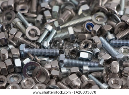 various, various bolts, nuts, screws and washers lying all together in a heap, top view