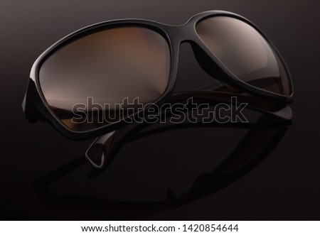 Sunglasses on a dark background, close up