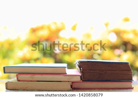 Close-up of old books stacked Multicolored light from nature as background selective focus and shallow depth of field