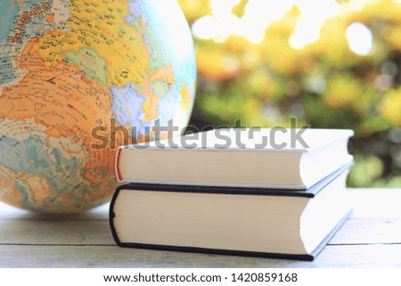 Close-up of stacked books Orb and multicolored light from nature as the background selective focus and shallow depth of field