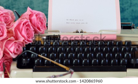 Romantic vintage feminine writing scene, tea break with old typewriter and pink roses.