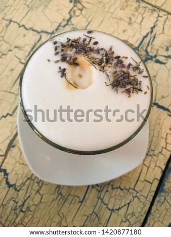 Lavender coffee late decorated real flowers on the old vintage table. Smartphone pictures concept