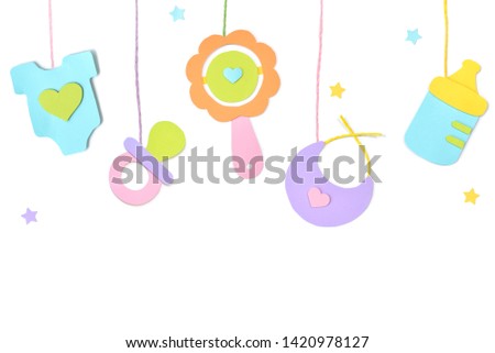 Baby toys hanging paper cut on white background - isolated