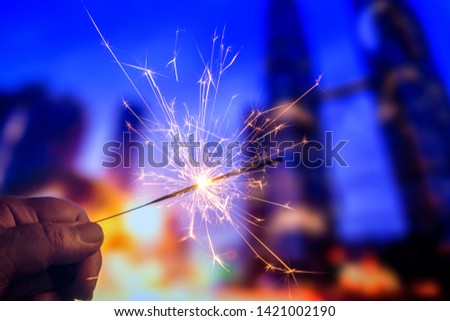 Playing firecrackers sparklers for celebration Christmas, Diwali, Eid Mubarak and all world festival party with blurry background.