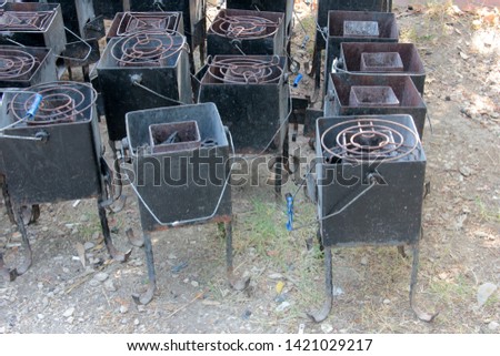 wrought-iron grill with a chimney barbecue outdoor