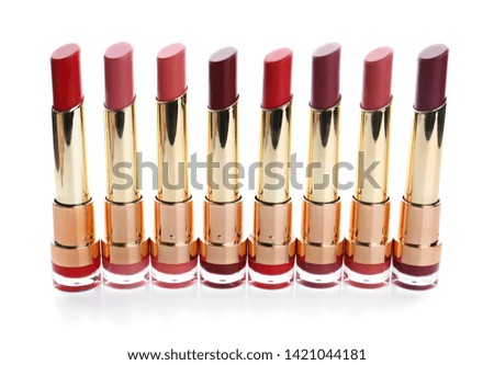 Many different stylish lipsticks on white background