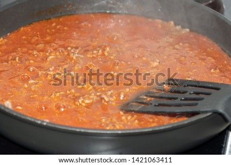 Cooking bolognese sauce in pan - iatalian food