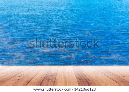 Old plank with blue sea background for displaying products