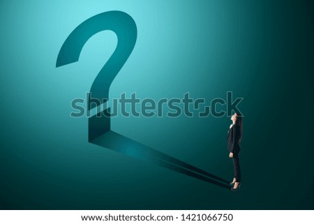 Young businesswoman with blue question mark shadow. Confusion and think concept