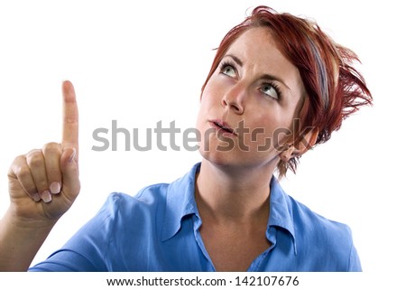 young redhead woman pointing at copyspace