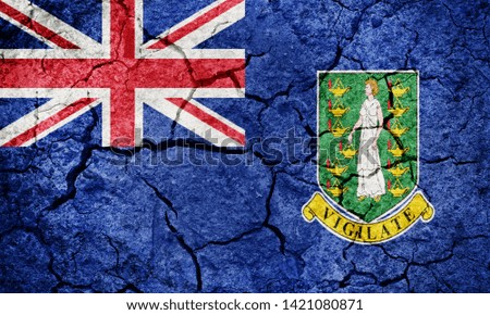Flag of the British Virgin Islands on dry earth ground texture background