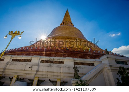 The background of a large pagoda (Phra Pathom Chedi) located in Nakhon Pathom in Thailand, is visited by tourists, making merit and taking public pictures while traveling.