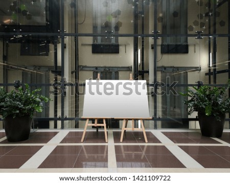 Modern interior with glass partitions and empty canvas. Template for art works, advertisement, flyers.
