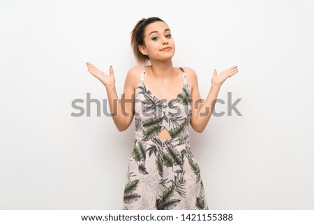 Young woman over isolated white background making doubts gesture