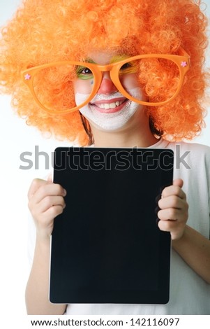 Portrait of happy funny clown kid holding tablet for your message