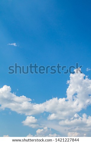Pronounced white clouds. White cumulus clouds on a blue sky in the afternoon.