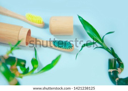 Flat lay composition with bamboo toothbrushes and space for text on blue background