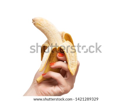 Female hand holding banana. Isolated on white background
