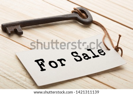 House for Sale - real estate concept, old key with For Sale tag