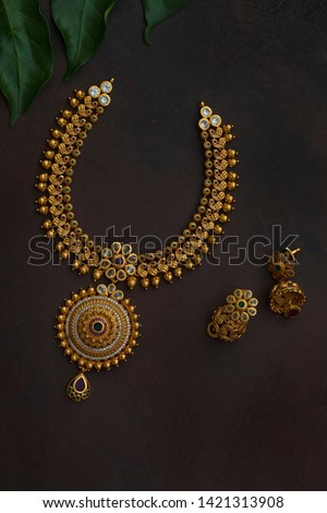 indian ethnic jewellery on dark background Royalty-Free Stock Photo #1421313908