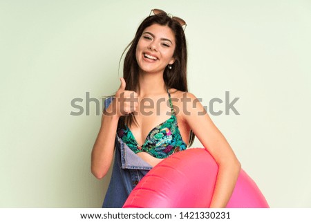 Teenager girl on summer vacation giving a thumbs up gesture