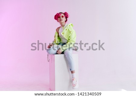 woman sitting on a retro style cube
