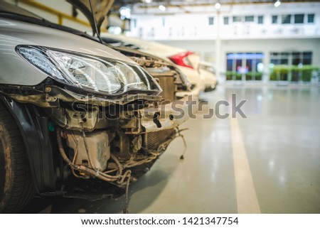 Car accident, parking, waiting in queue to repair the car at the repair shop in the repair center, the front bumper car damaged by accident. Royalty-Free Stock Photo #1421347754